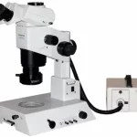Image of a white with black features electronic microscope and white control box.