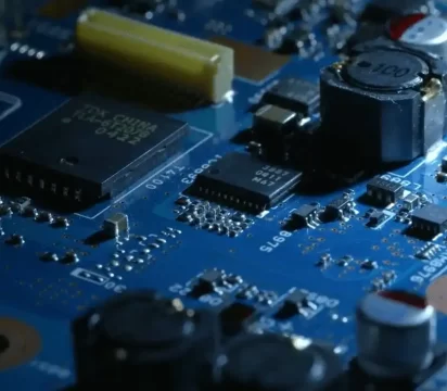 Blue assembled printed circuit board, dynamically light, casting dark shadows